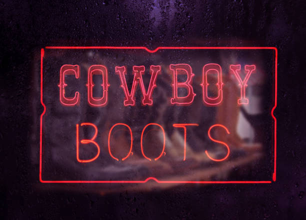 istock Vintage Neon Sign in Store Window Cowboy Boots 1369854570