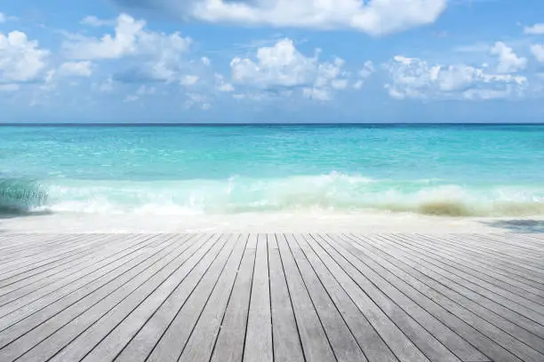 Photo of Empty wooden platform and tropical turquoise sea with blue sky background