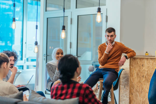 istock Business meeting between multi ethnic colleagues in a modern startup company. 1369857529