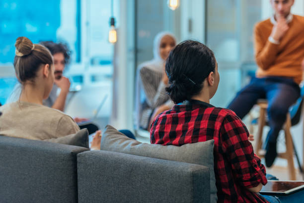 istock Business meeting between multi ethnic colleagues in a modern startup company. 1369857531