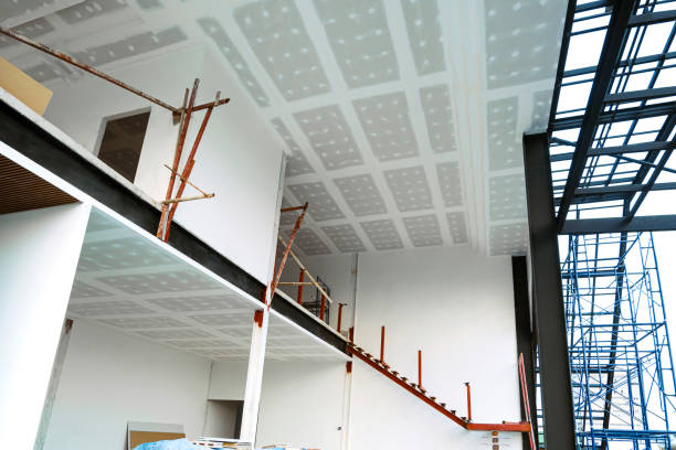 istock Bottom view of unfinished internal modern office building structure with materials in construction site 1369860151