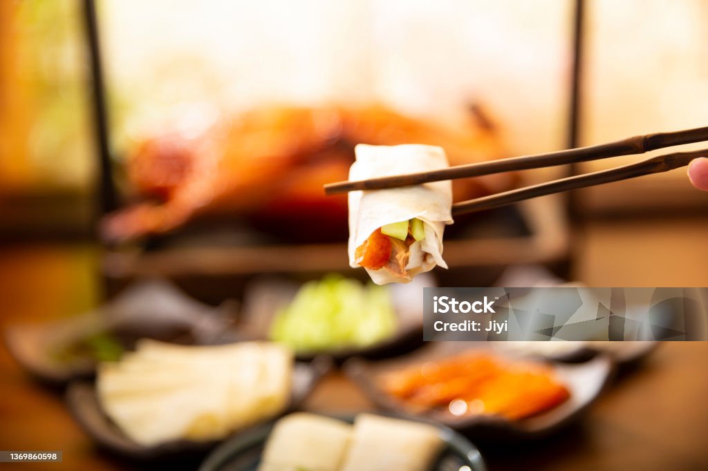 Chinese cuisine,Close-up of Beijing roast duck spring roll China's most famous traditional food, Beijing roast duck Chopsticks Stock Photo