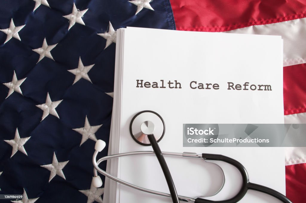 Health Care Reform Bill Law Health care reform bill / law on an American flag. American Culture Stock Photo