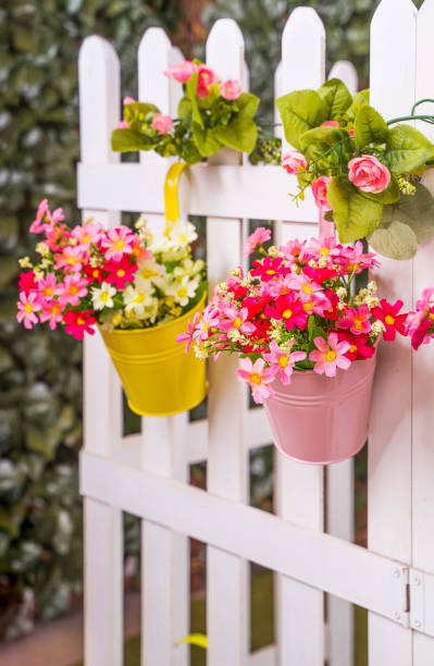 istock Hanging Flower Pots with fence 1369864704