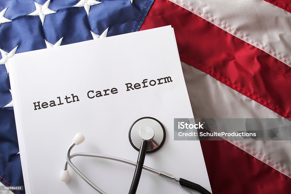 Health Care Reform Bill Law Health care reform bill / law on an American flag. Healthcare And Medicine Stock Photo