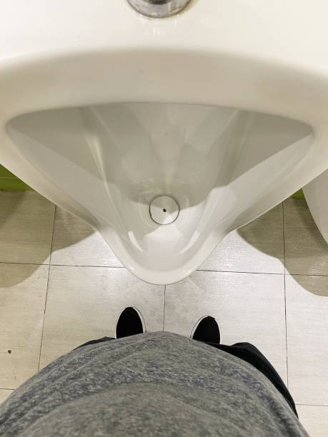 istock man and urinal in toilet 1369868239