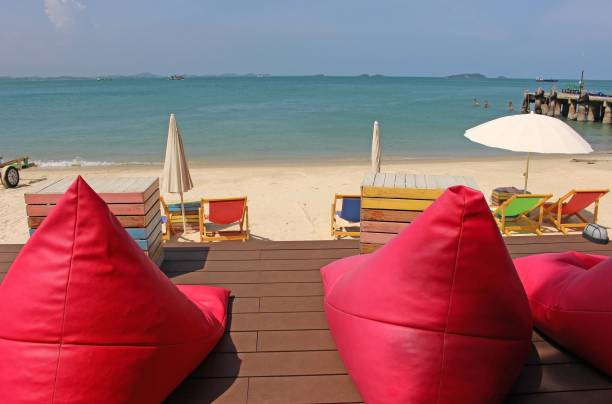 istock Terrace with large pink cushions by the beach 1369871507