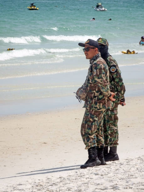 Rayong, Thailand - June 24th, 2018: Soldiers watch over the safety of tourists on Sai Kaew Beach, a popular tourist attraction on Kah Samed Island, eastern Thailand.