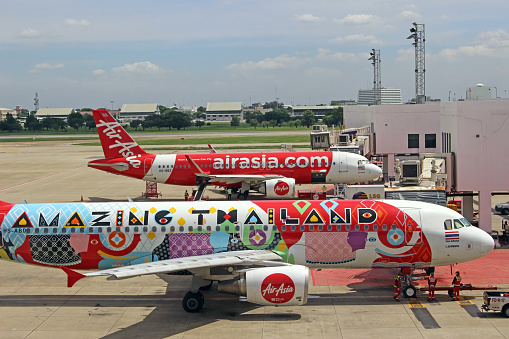 Bangkok, Thailand - October 16th, 2017: Two airplanes branded with Air Asia livery, including one with the \