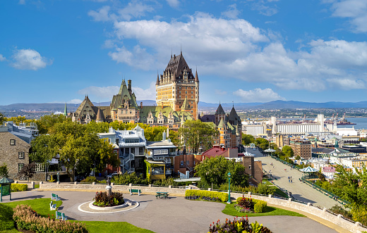 Panoramic view of Chateau Frontenac in Quebec historic center located on Dufferin Terrace promenade with scenic views and landscapes of Saint Lawrence River, upper town and Old Port.
