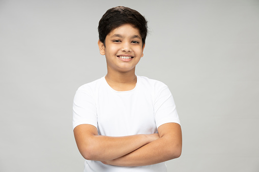 Portrait of attractive young school boy, white background,