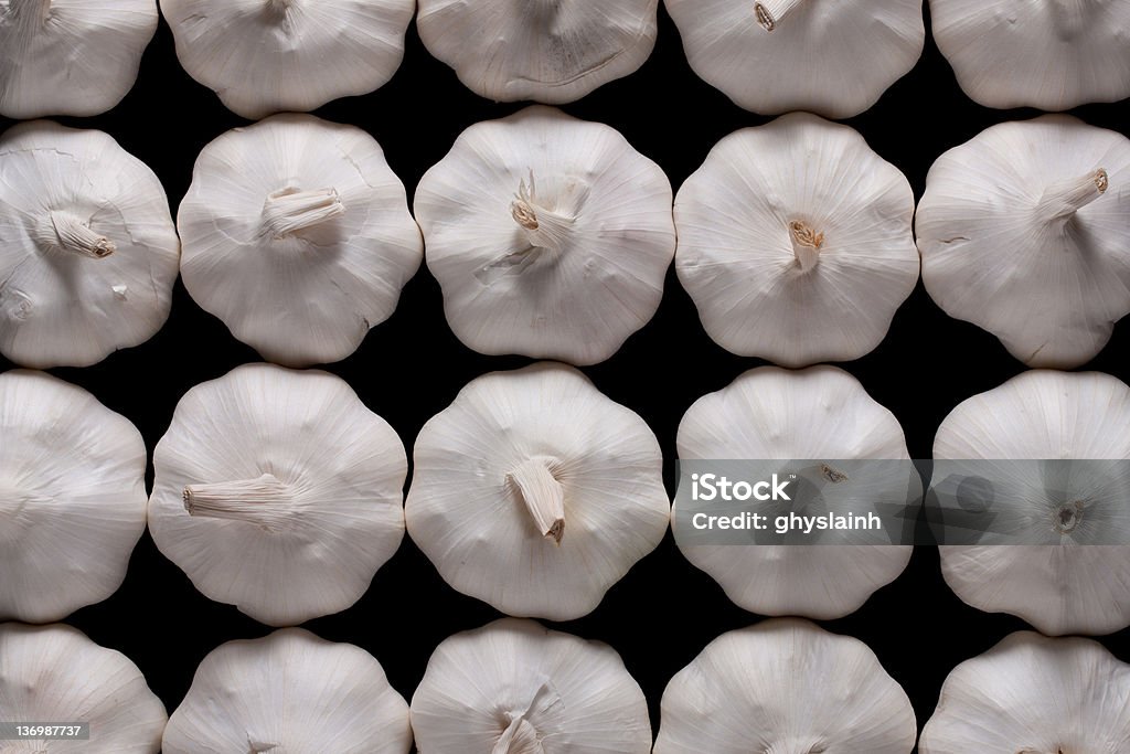 Garlic Heads in a Pattern Multiple garlic heads arranged in a rectangular pattern Food Stock Photo