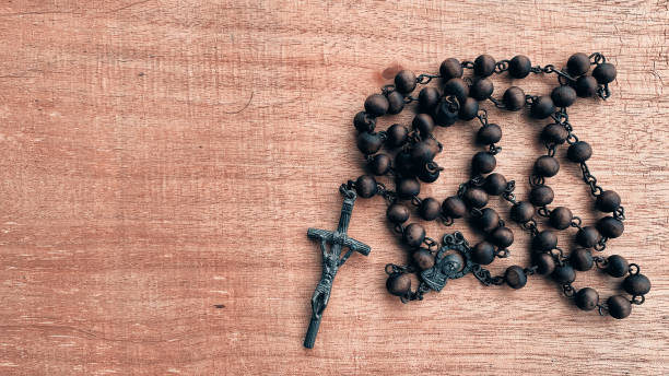 top view of holy rosary on wooden brown table. - prayer beads imagens e fotografias de stock