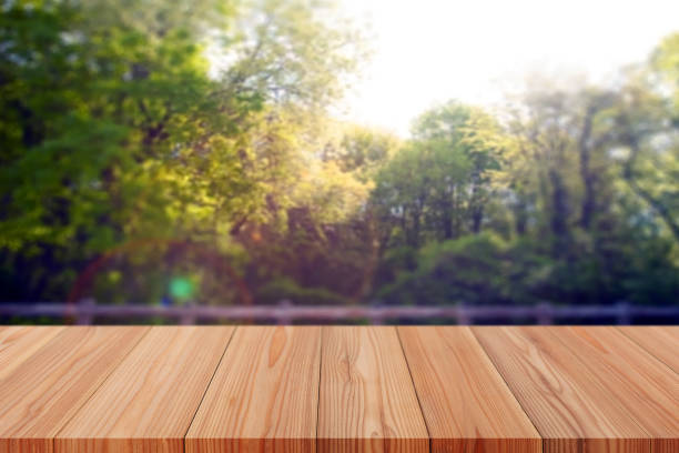 istock Perspective empty wooden table on top over blur background, can be used mock up for montage products display or design layout. 1369878788