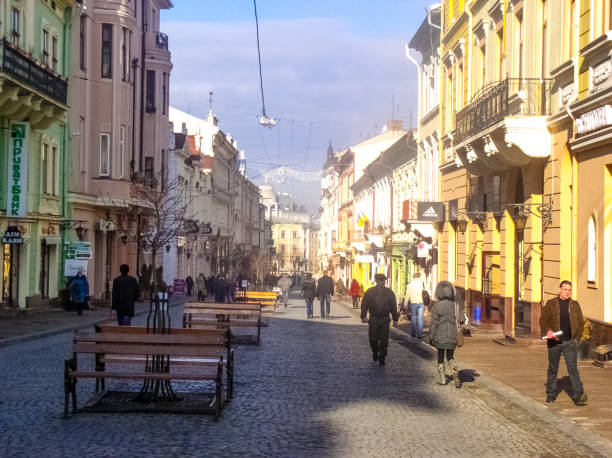 January 11, 2011, Kiev, Ukraine. People can be seen walking and enjoying the morning hours in the streets of Kiev.  This architecturally stunning street shows off the many buildings within the city.   On this cold day in winter, the brightly lit buildings shine, offering stunning views for all who walk the streets.
