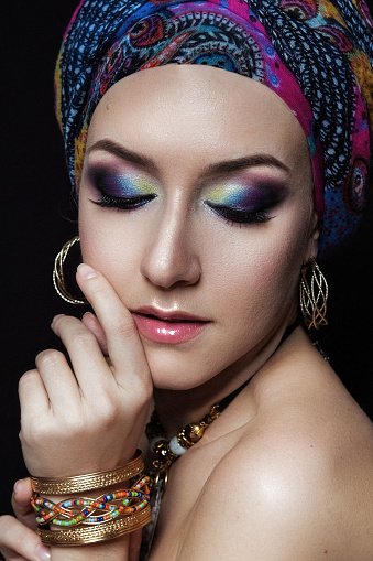 Portrait of a female model in ethnic indian costume with jewellery and traditional makeup.