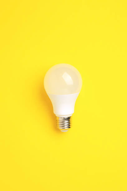 istock LED lamp on a yellow background. Energy saving concept, alternative energy sources, idea 1369883370