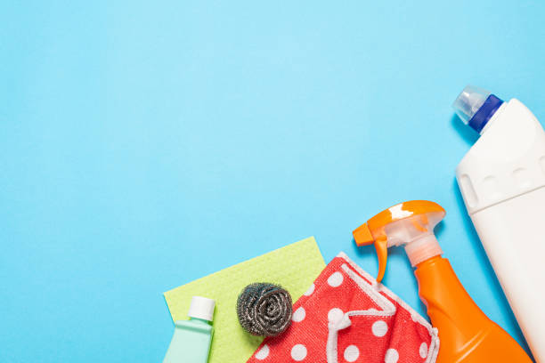 istock bottles and sprays cleaning agent brushes sponges rags on a colored background on the side. Professional cleaning products, general cleaning. Household chemicals 1369883535