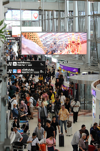 Samut Prakan, Thailand - 8th September, 2019: Electronic sign at Suvarnabhumi Airport welcomes tourists as they walk through arrivals.  Chinese text translates as 