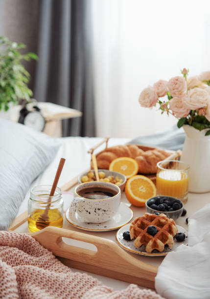 Breakfast in bed Romantic breakfast with coffee, croissants and rose flowers. bed breakfast pictures stock pictures, royalty-free photos & images