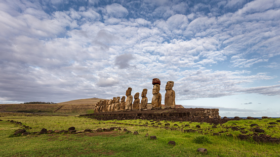 Easter Island Ahu Tongariki Panorama. Fifteen ancient civilization polynesian Moai Statues standing side by side in a row along the pacific ocean coast under sunny summer sky with fluffy cloudscape. Wide Angle Panorama Shot. Rapa Nui. Easter Island, Isla de Pascua, Polynesia, Chile, Oceania