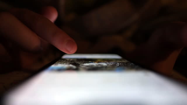 Hand scrolling through photos on smart phone