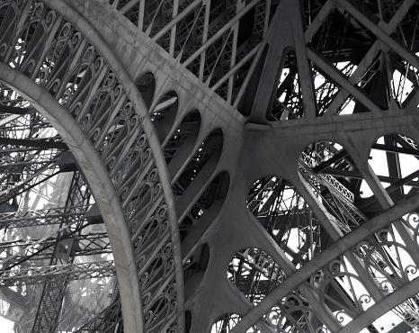 View of the elements and patterns of metal structures of the Eiffel Tower. Patterns, decor and design of steel supports, attachment points and intersections of the bearing elements of the tower.