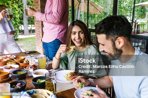 istock Group of latin friends eating mexican food in the restaurant terrace in Mexico Latin America 1369889148