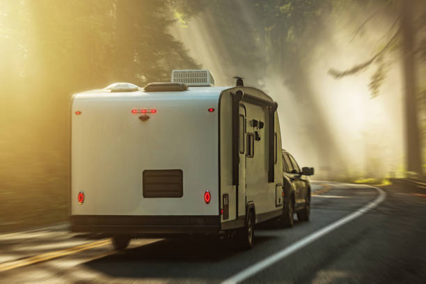 Travel Trailer RV Scenic Route Road Trip Travel Modern Travel Trailer RV Scenic Route Road Trip Travel Through Foggy Redwood Forests of Northern California, United States of America. camper trailer stock pictures, royalty-free photos & images