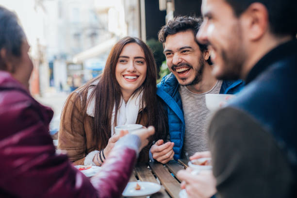 istock Friends talking and laughing in a cafe 1369891114