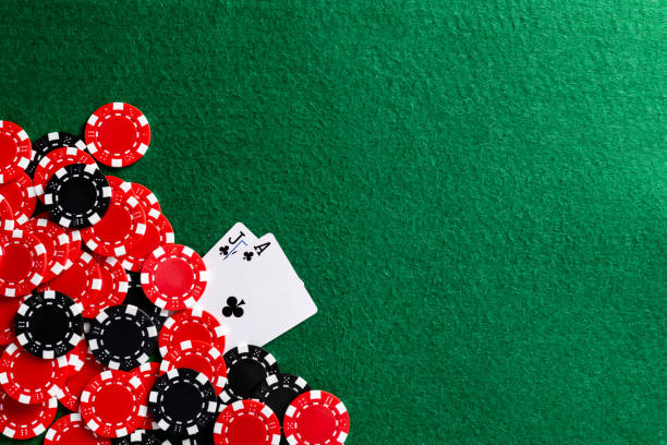 istock Playing cards and gambling chip on the table 1369892494