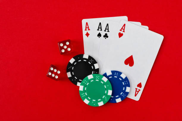 istock Four aces and gambling chips on red background 1369892710