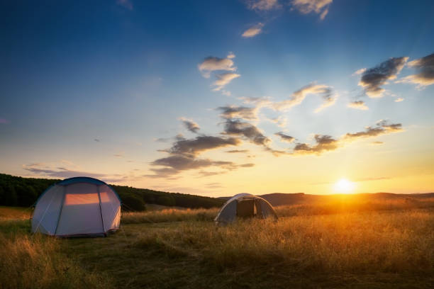 istock Blue and green tents in the mountains under dramatic morning sky 1369892719