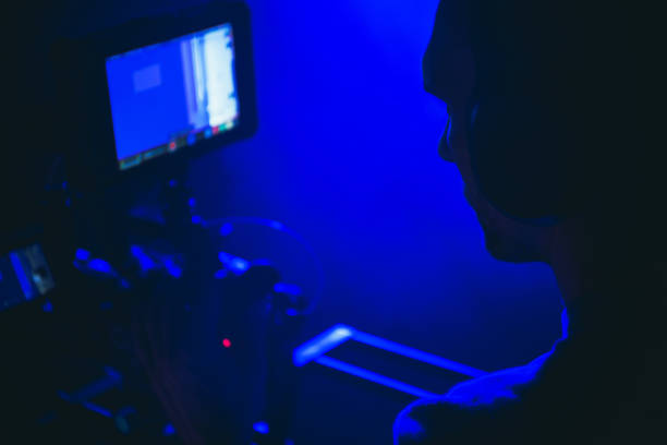 istock Television and Digital Motion Picture Theme with Caucasian Camera Operator Behind the Lens. 1369896293