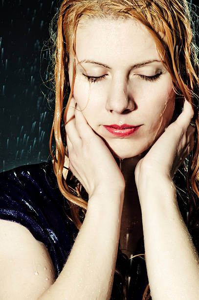 istock Young beautiful woman under falling water 136989726