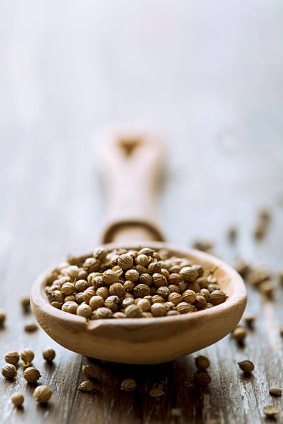 istock Wooden spoon full of coriander seeds 136989801