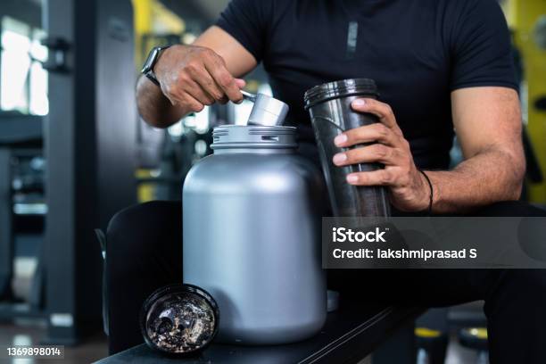 Close Up Shot Of Bodybuilder Hands Taking Protein Powder And Mixing With Water On Bottle By Shaking At Gym Concpet Of Muscular Gain Nutritional Supplement And Wellness Stock Photo - Download Image Now