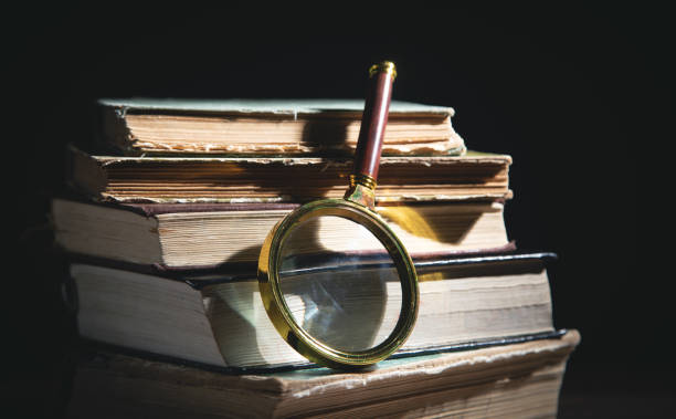istock Magnifying glass and book. Education 1369898758