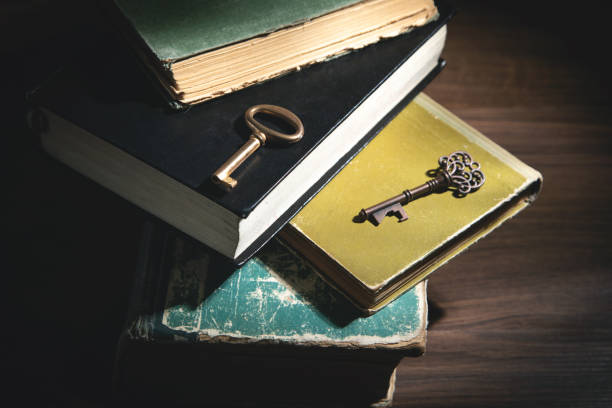 istock Books and old keys on the wooden table. 1369898762