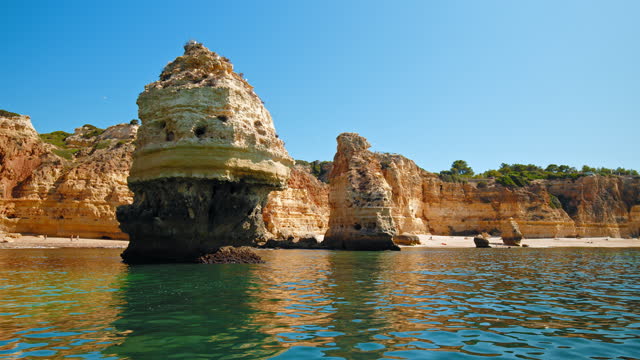 Algar de Benagil and other Coastal Caves in Algarve, Portugal from a boat.
