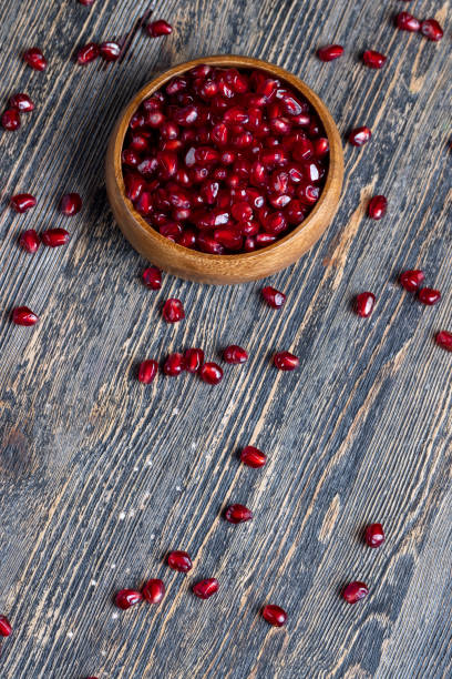 istock scattered pomegranate seeds on a wooden board 1369898939