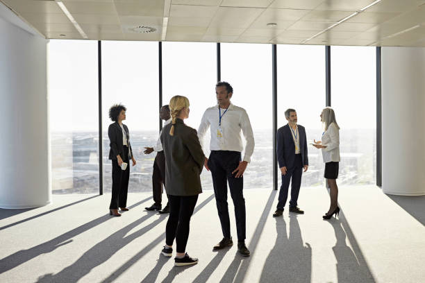 istock Dramatic view of mixed age executives in corporate office 1369899336