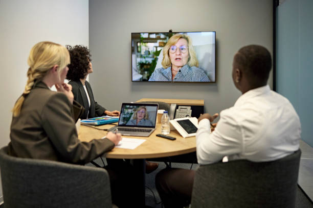 istock Young executives listening to manager on video call 1369899380