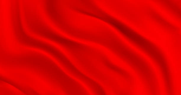 istock Luxurious red smooth fabric background with waves. Wavy folds of a noble textile background. Red matte fabric flutters in the wind. Decoration element for design 1369902702