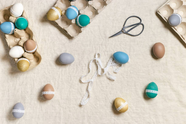 istock Easter eggs decoration top view table, tape lace for decorating colorful chicken egg, traditional holiday food.   Home preparing for  Happy Easter. Diy symbol of spring holiday, flat lay 1369903206