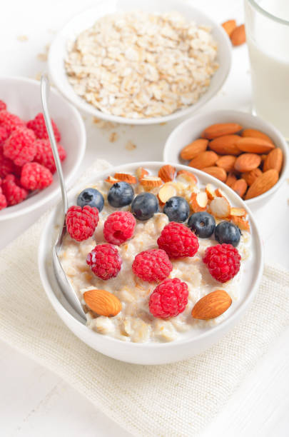 istock Oatmeal porridge with raspberries, blueberries and nuts 1369905484