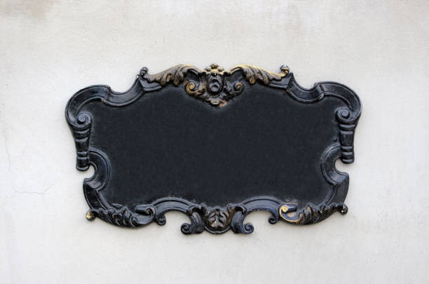 Gothic scroll style black wall plaque Vintage gothic style blank black metal wall plaque or sign with decorative swirly edges with gold coloring memorial plaque stock pictures, royalty-free photos & images