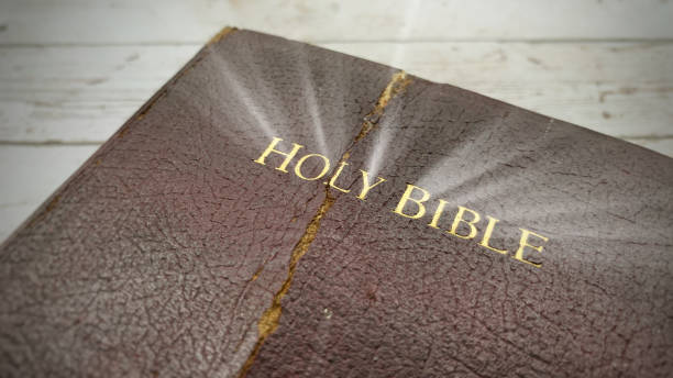 istock Top view on an old Holy Bible with shining light. Christianity concept. 1369909978