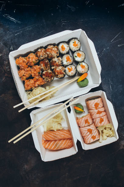 istock Delivery in boxes of sushi rolls 1369910332