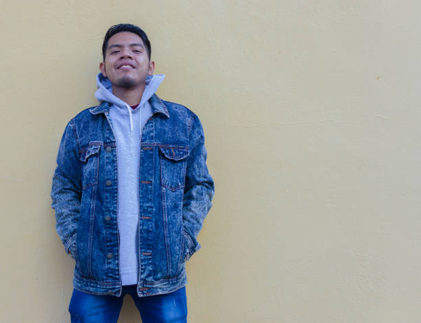 istock modern indigenous guy from mexico standing alone on unicolor background 1369910397